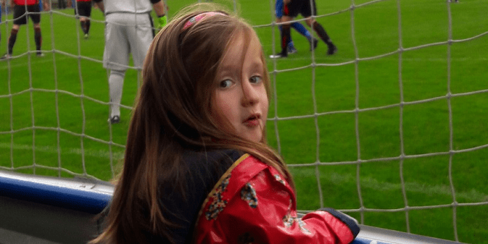 girl-watching-soccer-match.png